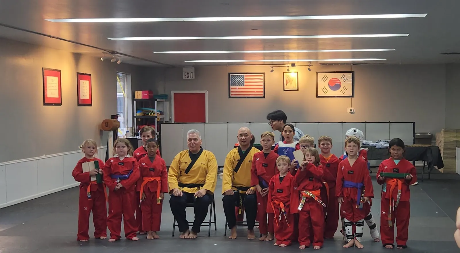 Young students in red uniforms with their master at Oh's Martial Arts in Seminole